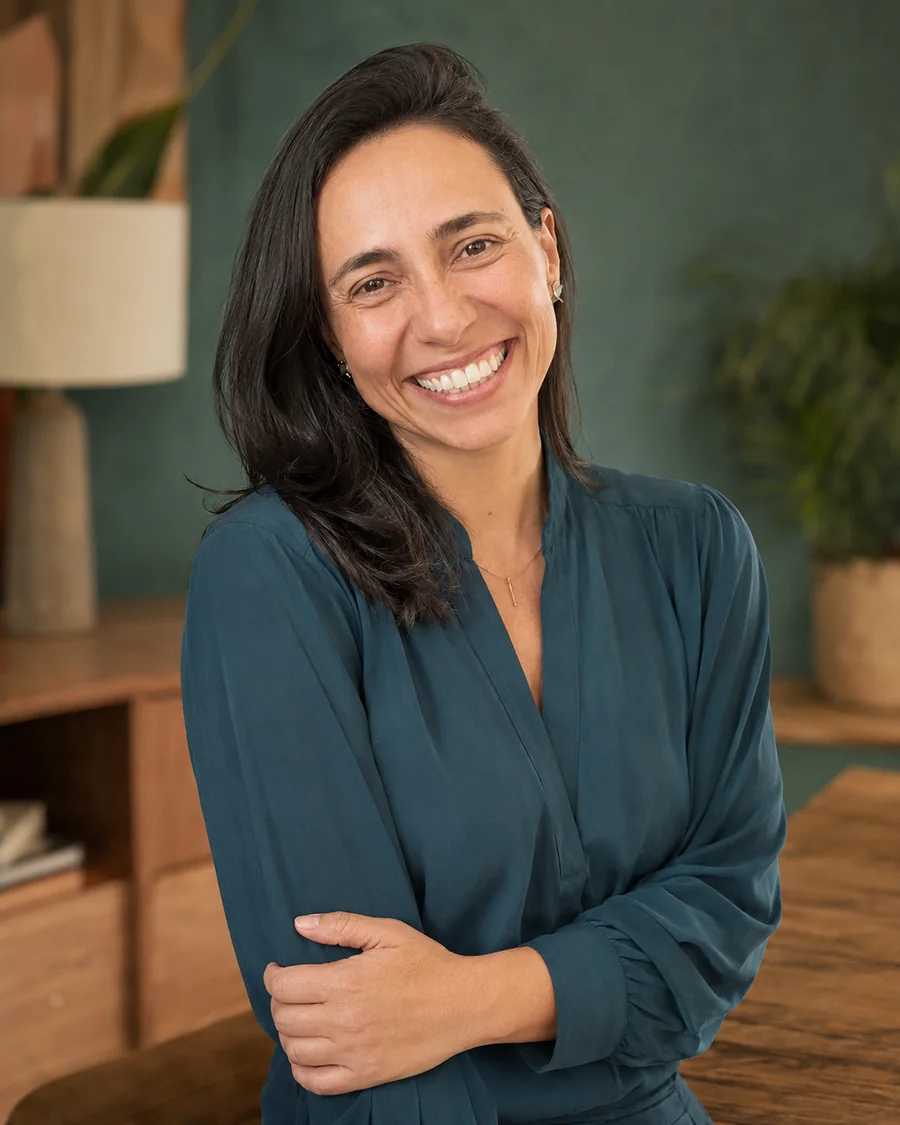 Fabi smiling in a teal blouse